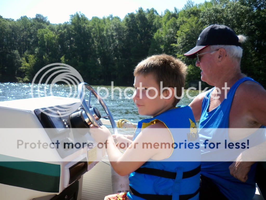 Dylan driving boat at Lake Anna