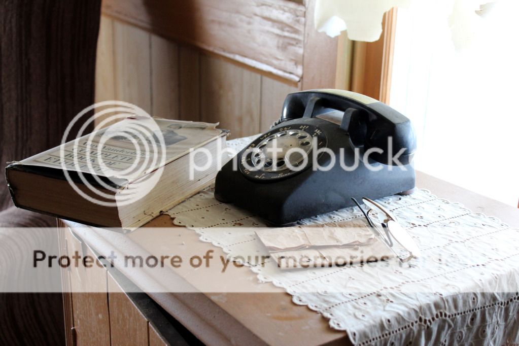 Antique phone with book and glasses